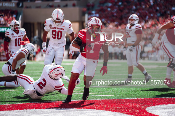 Wisconsin Badgers running back Chez Mellusi #1 scores a touchdown against the South Dakota Coyotes at Camp Randall Stadium in Madison, Wisco...