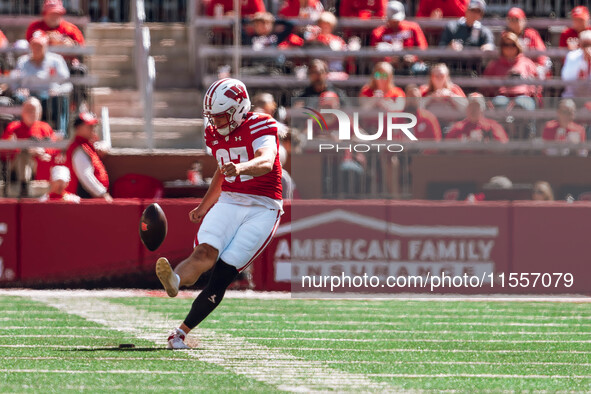 Wisconsin Badgers kicker Gavin Lahm #97 kicks off against the South Dakota Coyotes at Camp Randall Stadium in Madison, Wisconsin, on Septemb...