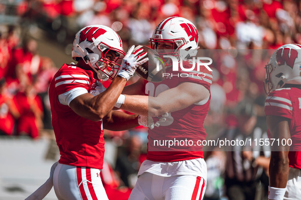 Wisconsin Badgers wide receiver C.J. Williams #4 celebrates a touchdown against the South Dakota Coyotes with Wisconsin Badgers tight end Tu...