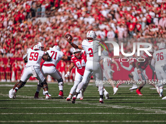 South Dakota quarterback Aidan Bouman #2 attempts a pass against the Wisconsin Badgers at Camp Randall Stadium in Madison, Wisconsin, on Sep...