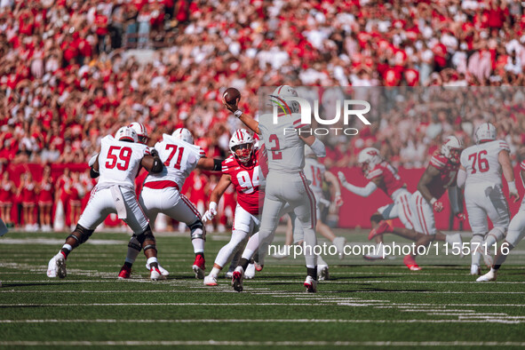 South Dakota quarterback Aidan Bouman #2 attempts a pass against the Wisconsin Badgers at Camp Randall Stadium in Madison, Wisconsin, on Sep...