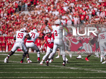 South Dakota quarterback Aidan Bouman #2 attempts a pass against the Wisconsin Badgers at Camp Randall Stadium in Madison, Wisconsin, on Sep...