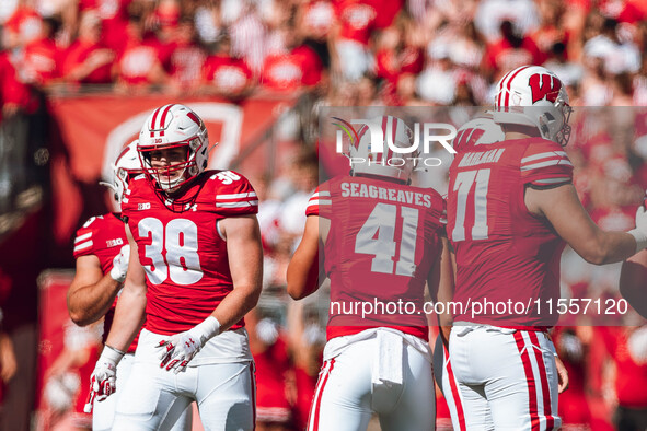 Wisconsin Badgers tight end Tucker Ashcraft #38, tight end JT Seagreaves #41, and offensive lineman Riley Mahlman #71 are at Camp Randall St...