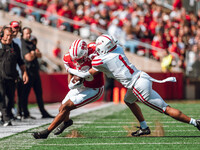 South Dakota defensive back Roman Tillmon #1 tackles Wisconsin Badgers wide receiver Bryson Green #9 at Camp Randall Stadium in Madison, Wis...