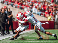 South Dakota defensive back Roman Tillmon #1 tackles Wisconsin Badgers wide receiver Bryson Green #9 at Camp Randall Stadium in Madison, Wis...