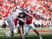 Wisconsin Badgers outside linebacker Aaron Witt #59 takes on South Dakota offensive lineman Bryce Henderson #55 at Camp Randall Stadium in M...