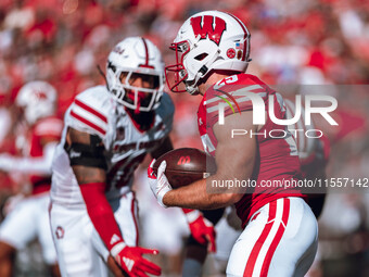 Wisconsin Badgers running back Cade Yacamelli #25 runs through the South Dakota Coyotes defense at Camp Randall Stadium in Madison, Wisconsi...