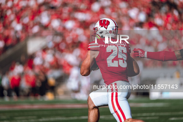 Wisconsin Badgers running back Cade Yacamelli #25 runs through the South Dakota Coyotes defense at Camp Randall Stadium in Madison, Wisconsi...