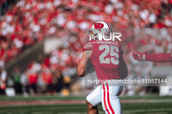 Wisconsin Badgers running back Cade Yacamelli #25 runs through the South Dakota Coyotes defense at Camp Randall Stadium in Madison, Wisconsi...