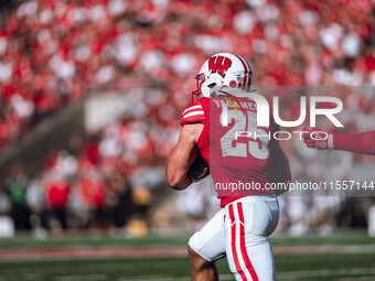 Wisconsin Badgers running back Cade Yacamelli #25 runs through the South Dakota Coyotes defense at Camp Randall Stadium in Madison, Wisconsi...