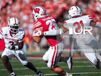 Wisconsin Badgers running back Cade Yacamelli #25 runs through the South Dakota Coyotes defense at Camp Randall Stadium in Madison, Wisconsi...