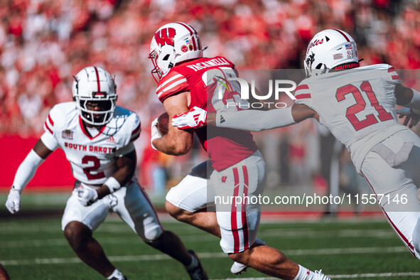 Wisconsin Badgers running back Cade Yacamelli #25 runs through the South Dakota Coyotes defense at Camp Randall Stadium in Madison, Wisconsi...