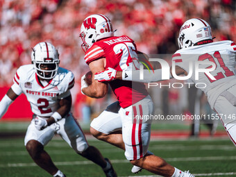 Wisconsin Badgers running back Cade Yacamelli #25 runs through the South Dakota Coyotes defense at Camp Randall Stadium in Madison, Wisconsi...