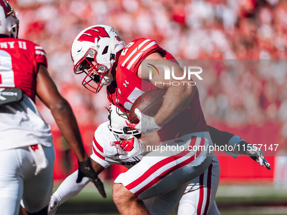 Wisconsin Badgers running back Cade Yacamelli #25 runs through the South Dakota Coyotes defense at Camp Randall Stadium in Madison, Wisconsi...