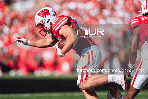 Wisconsin Badgers running back Cade Yacamelli #25 runs through the South Dakota Coyotes defense at Camp Randall Stadium in Madison, Wisconsi...