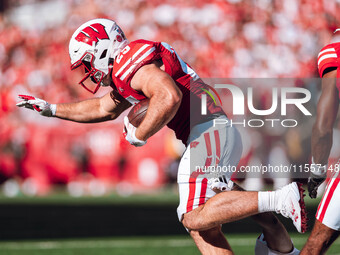 Wisconsin Badgers running back Cade Yacamelli #25 runs through the South Dakota Coyotes defense at Camp Randall Stadium in Madison, Wisconsi...