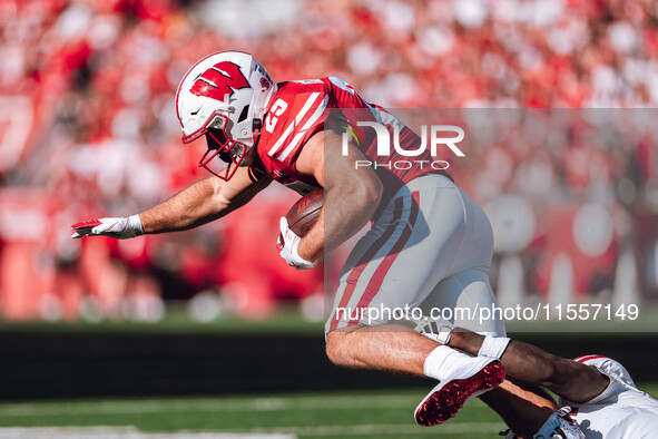 Wisconsin Badgers running back Cade Yacamelli #25 runs through the South Dakota Coyotes defense at Camp Randall Stadium in Madison, Wisconsi...