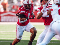 Wisconsin Badgers running back Chez Mellusi #1 takes a screen pass against the South Dakota Coyotes defense at Camp Randall Stadium in Madis...