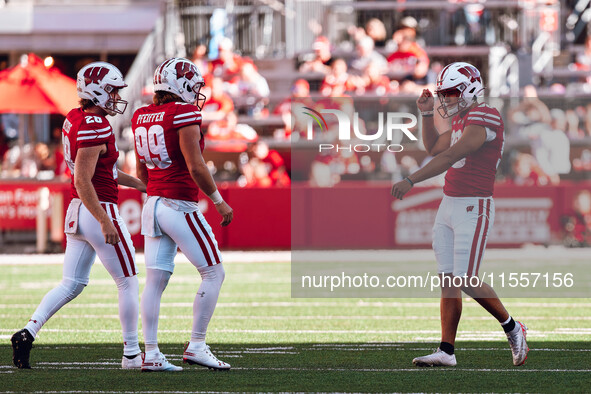 Wisconsin Badgers kicker Nathanial Vakos #90 celebrates a field goal with safety Cayson Pfeiffer #99 and punter Gavin Meyers #28 at Camp Ran...