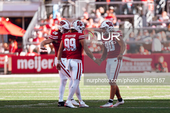 Wisconsin Badgers kicker Nathanial Vakos #90 celebrates a field goal with safety Cayson Pfeiffer #99 and punter Gavin Meyers #28 at Camp Ran...