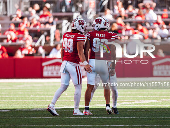 Wisconsin Badgers kicker Nathanial Vakos #90 celebrates a field goal with safety Cayson Pfeiffer #99 and punter Gavin Meyers #28 at Camp Ran...