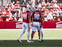 Wisconsin Badgers kicker Nathanial Vakos #90 celebrates a field goal with safety Cayson Pfeiffer #99 and punter Gavin Meyers #28 at Camp Ran...