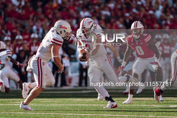 South Dakota quarterback Aidan Bouman #2 fakes a handoff to running back Travis Theis #5 at Camp Randall Stadium in Madison, Wisconsin, on S...