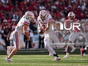 South Dakota quarterback Aidan Bouman #2 fakes a handoff to running back Travis Theis #5 at Camp Randall Stadium in Madison, Wisconsin, on S...