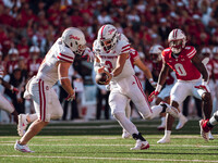 South Dakota quarterback Aidan Bouman #2 fakes a handoff to running back Travis Theis #5 at Camp Randall Stadium in Madison, Wisconsin, on S...