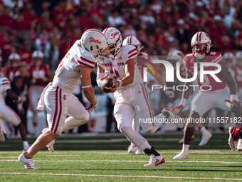 South Dakota quarterback Aidan Bouman #2 fakes a handoff to running back Travis Theis #5 at Camp Randall Stadium in Madison, Wisconsin, on S...