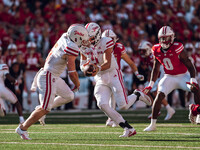 South Dakota quarterback Aidan Bouman #2 fakes a handoff to running back Travis Theis #5 at Camp Randall Stadium in Madison, Wisconsin, on S...