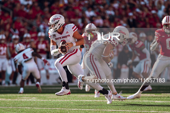 South Dakota quarterback Aidan Bouman #2 fakes a handoff to running back Travis Theis #5 at Camp Randall Stadium in Madison, Wisconsin, on S...