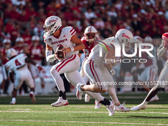 South Dakota quarterback Aidan Bouman #2 fakes a handoff to running back Travis Theis #5 at Camp Randall Stadium in Madison, Wisconsin, on S...