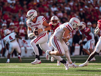 South Dakota quarterback Aidan Bouman #2 fakes a handoff to running back Travis Theis #5 at Camp Randall Stadium in Madison, Wisconsin, on S...