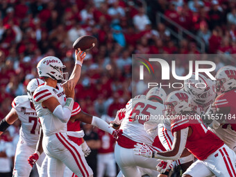 South Dakota quarterback Aidan Bouman #2 attempts a pass against the Wisconsin Badgers at Camp Randall Stadium in Madison, Wisconsin, on Sep...