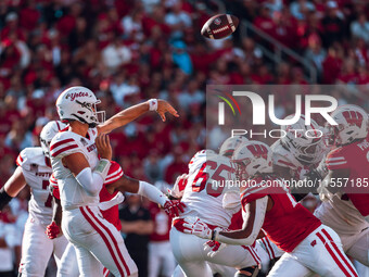 South Dakota quarterback Aidan Bouman #2 attempts a pass against the Wisconsin Badgers at Camp Randall Stadium in Madison, Wisconsin, on Sep...