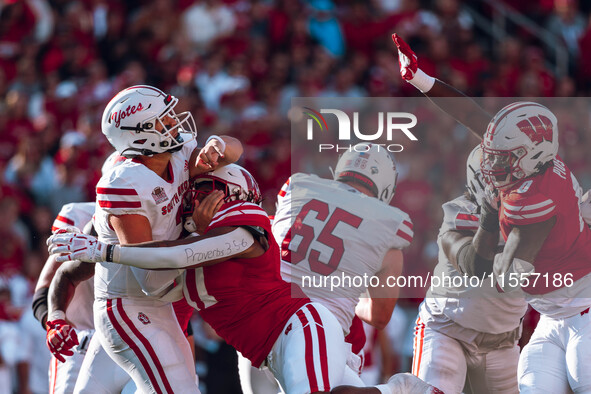 South Dakota quarterback Aidan Bouman #2 attempts a pass against the pressure of Wisconsin Badgers outside linebacker Darryl Peterson #17 at...