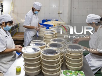 Workers pack mooncakes at a workshop of Oriental Pastry Co., LTD., a time-honored pastry company in Taizhou, China, on September 8, 2024. (