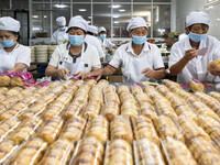 Workers pack mooncakes at a workshop of Oriental Pastry Co., LTD., a time-honored pastry company in Taizhou, China, on September 8, 2024. (