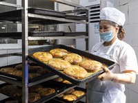 A worker prepares mooncakes for packaging at the production workshop of Oriental Pastry Co., LTD., a time-honored pastry company in Taizhou,...