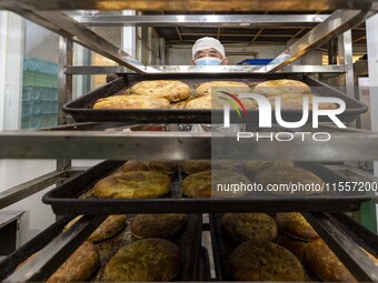 A worker prepares mooncakes for packaging at the production workshop of Oriental Pastry Co., LTD., a time-honored pastry company in Taizhou,...