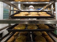 A worker prepares mooncakes for packaging at the production workshop of Oriental Pastry Co., LTD., a time-honored pastry company in Taizhou,...