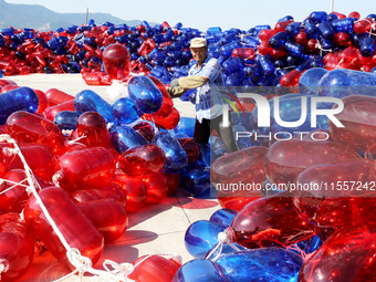 Fishermen prepare floats for shipment in Lianyungang, China, on September 8, 2024. (