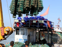 Fishermen hoist oyster cage seedlings for sea release in Lianyungang, China, on September 8, 2024. (