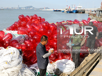 Fishermen load a floating ship to be transported to a breeding area in Lianyungang, China, on September 8, 2024. (