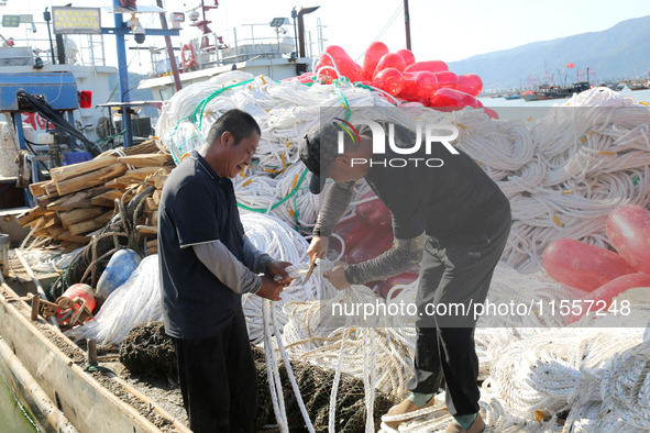 Fishermen load a floating ship to be transported to a breeding area in Lianyungang, China, on September 8, 2024. 