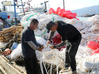 Fishermen load a floating ship to be transported to a breeding area in Lianyungang, China, on September 8, 2024. (