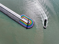 Coastal fishermen drive a fishing boat to transport oyster cage seedlings to a breeding area for spreading and stocking in Lianyungang, Chin...