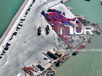 Fishermen load a floating ship to be transported to a breeding area in Lianyungang, China, on September 8, 2024. (