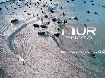 Fishermen drive various kinds of aquaculture boats in the coastal aquaculture zone in Lianyungang, China, on September 8, 2024. (